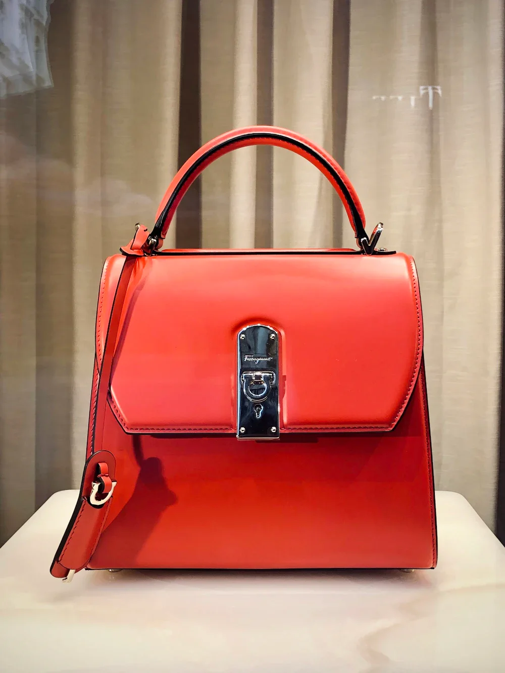 Minimalist luxury leather handbag on elegant display stand
